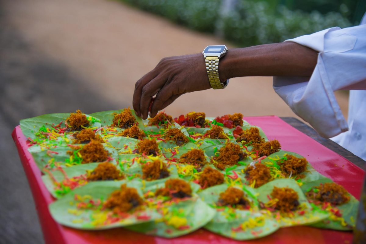 person standing near table with cook foods